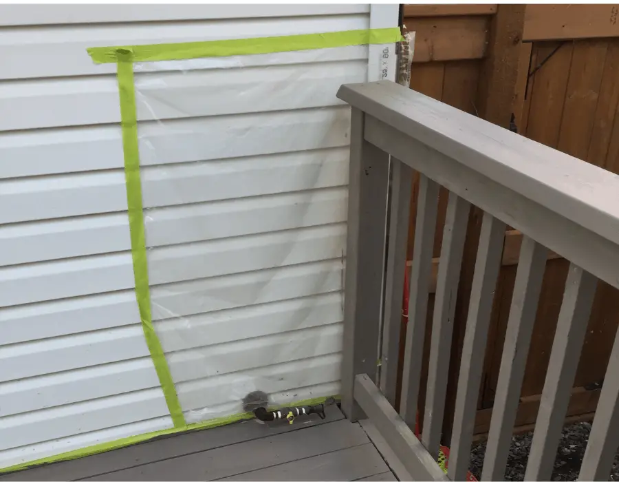 Protect house with plastic when staining deck